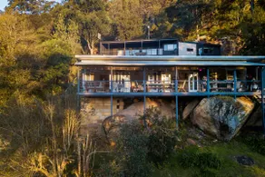 Water, trees, sky and a house on the rocks. - Image 2