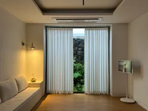 Your Isle / A private multi-story house with stone walls and plants - Image 2