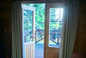 Log cabin surrounded by the warmth of wood [Log cabin with vibrant fall foliage] - Image 3