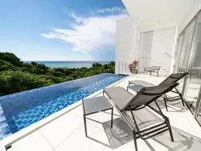 Blue Rela Luxe Resort Okinawa, a villa with a pool surrounded by nature - Image 2