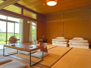 A house with a large veranda, tatami room, and open kitchen with a ceiling fan. The kitchen and bathroom are equipped with the latest facilities. - Image 5