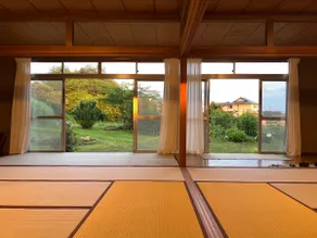 A house with a large veranda, tatami room, and open kitchen with a ceiling fan. The kitchen and bathroom are equipped with the latest facilities. - Image 3