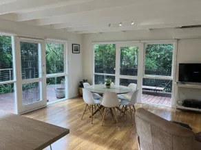 Secluded beach cottage surrounded by trees - Image 2