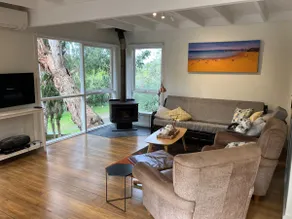 Secluded beach cottage surrounded by trees - Image 4