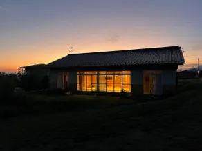A house with a large veranda, tatami room, and open kitchen with a ceiling fan. The kitchen and bathroom are equipped with the latest facilities. - Image 2