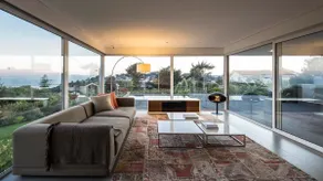 Modern house with ocean views and a large garden. - Image 5