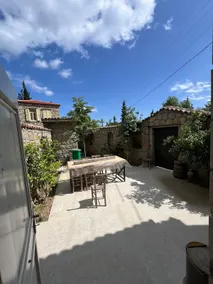 Stone house with a historical courtyard in Adatepe village square - Image 5