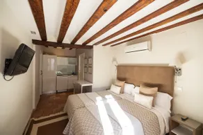 A room with a kitchen. - Image 3