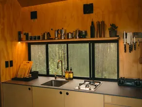 Designer Off-Grid Cabin Hidden in the Vines - Image 4