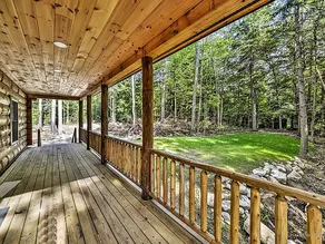 Modern lakefront log cabin with sunset views. - Image 3