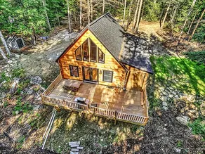 Modern lakefront log cabin with sunset views. - Image 2