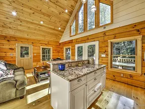 Modern lakefront log cabin with sunset views. - Image 5