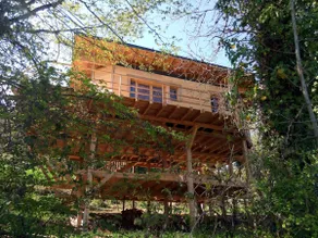 Wooden and straw house on stilts. - Image 2