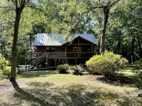 A charming cedar log cabin tucked in the woods. - Image 2