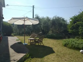 Detached cottage surrounded by greenery with a park. - Image 2