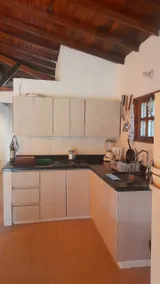 House surrounded by nature and a fireplace inside - Image 5