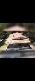 House surrounded by nature and a fireplace inside - Image 2