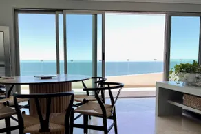 A beachfront property with a view of the marina and a heated pool - Image 2