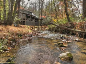 Indulge in "Just One More Night", a pet-friendly creekfront retreat boasting a spacious outdoor deck, hot tub, firepit, and WiFi - Image 5