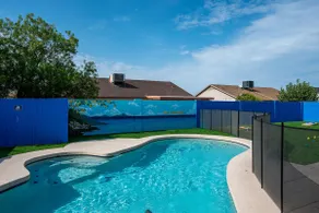 An oasis featuring a pool, where quiet luxury meets backyard tranquility. - Image 2