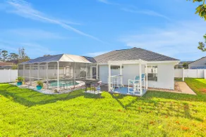 Contemporary coastal escape with heated pool, fenced yard, & outdoor dining - Image 4