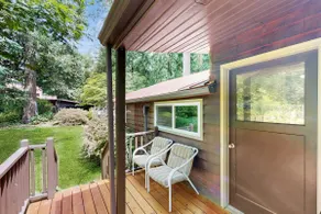 Tranquil landscape with riverside firepit gas grill gas fireplace and deck - Image 3