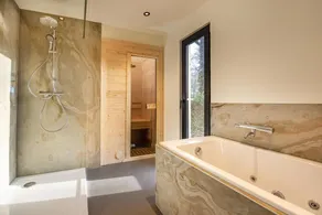 Wellness cottage with private sauna and hot tub for relaxing days surrounded by forest. - Image 2
