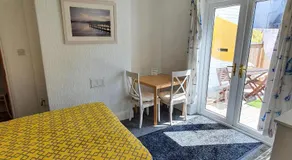 PAIGNTON S ONLY Ground floor Garden 2 Bedroom Apartment in front of the Pier & your Very own Private FREE Car space ,2 Double beds , 2 Single Beds , Kitchen , Air Fryer , 50 Blue ray Films ,Hotel Reception to Greet & Happily Help you - Image 4
