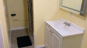 Private suite with small kitchen private bathroom entrance porch and driveway - Image 2