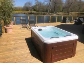 Chalet with a hot tub and terrace above the water - Image 5