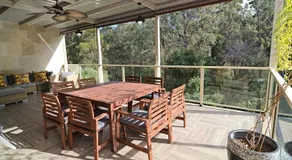 Coastal family retreat sun-drenched outdoor patio - Image 4