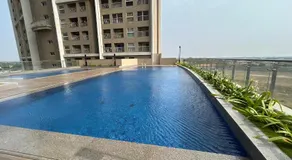 Spacious 2BHK Apartment in GIFT City for Families & Pros with Free Parking and pool - Image 4