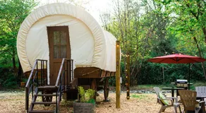 Cozy Wild West Covered Wagon next to River - Image 3