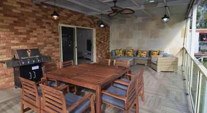 Coastal family retreat sun-drenched outdoor patio - Image 5