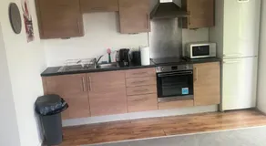 Cozy 2 Bed Apartment with Balcony Etihad Views, Steps from Coop Live - Image 4
