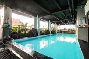 Homey Studio No Kitchen at Grand Darmo Suite Apartment By Travelio - Image 4