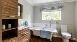 En-suite with double bed on mezzanine and desk in family home - Image 2