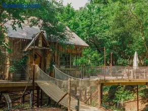 Hobbit Treehouse with waterfall on the Brazos River! 350 acres! Tubing! Petting zoo! - Image 1