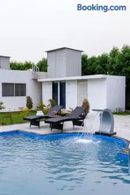 ELIVAAS Signature Malik Farms Countryside Wooden Cottage on 2 Acre Estate with Shared Pool, Garden & Restaurant - Image 1