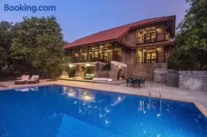 SaffronStays Vedika - 4BR riverfront pool villa with kaya king bullock ride & BBQ near Pinjal River, Vikramgad - Image 1