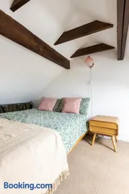 En-suite with double bed on mezzanine and desk in family home - Image 1