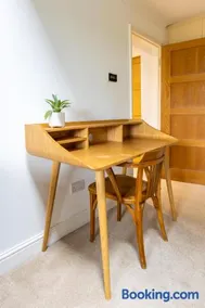 En-suite with double bed on mezzanine and desk in family home - Image 5