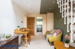 En-suite with double bed on mezzanine and desk in family home - Image 3