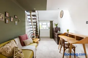 En-suite with double bed on mezzanine and desk in family home - Image 2