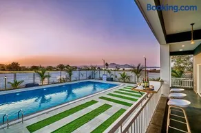 SaffronStays Six Oaks - 4BR Lakeside Villa with Pool, Games Room & Backwater Views - Image 1