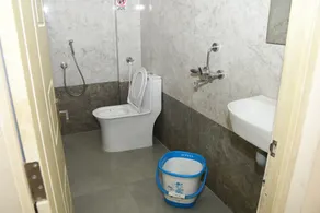 Vasantham Inn - Baño