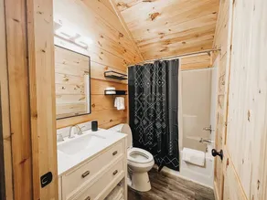Cabin #4: Two queen-size beds with a kitchenette and a large gravel parking pad beside the cabin for easy boat or trailer storage. - Image 3
