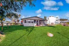 Lakefront home with water views, foosball, screened porch, & private W/D - Image 1