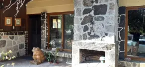 Cozy country cottage with wooden ceilings and stone walls within nature reserve. - Image 5