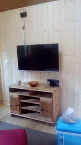 The holiday home \"Ortheide 69\" is located in a forest settlement with large trees. - Image 3
